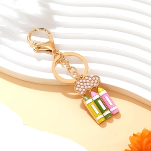Cute gold keychain with pearl cloud and colorful enamel pencils for school season