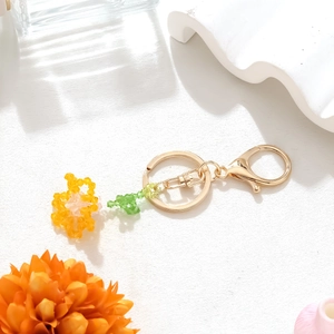 Detailed view of handmade crystal carnation bead pendant with a golden metal keychain