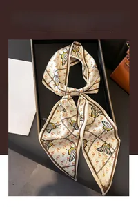 Detail of elegant butterfly and chain print silk scarf on a minimalist display