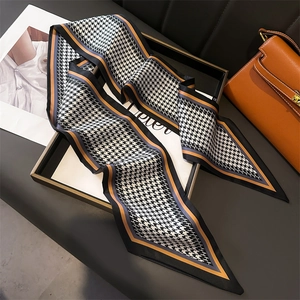 Houndstooth silk twilly scarf with letter H pattern and colorful borders on luxury bag