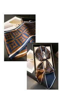 Detail showing geometric patterned narrow silk scarf with blue and brown diamond print