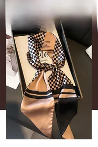 Detail of silk scarf with champagne houndstooth pattern and elegant script print