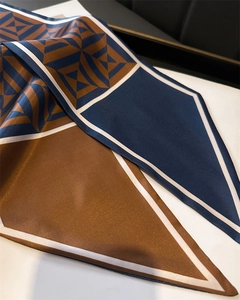 Detailed view of geometric color-block silk scarf in navy, brown and white patterns