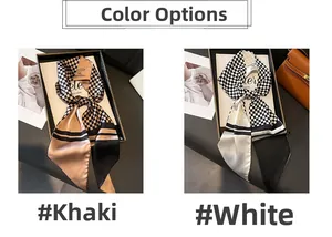 Close-up of houndstooth plaid silk twilly scarves in khaki and white color options