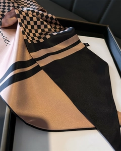 Detail of satin houndstooth scarf showing rose gold and black geometric silk textures