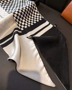 Detail of satin houndstooth scarf with classic black and white pattern textures