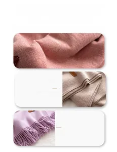 Detail of wool blend scarves showing soft knitted texture and fringe edges in pastel colors