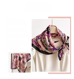 Detail of a purple paisley square scarf with glossy silk texture and vintage prints