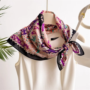 Elegant purple and red paisley silk-like square scarf tied on a white blouse collar