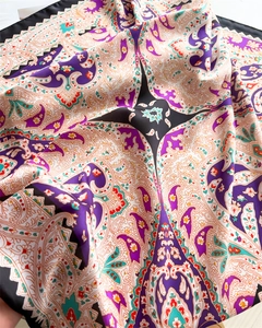 Close-up of silky paisley scarf showing detailed bohemian print and smooth fabric texture