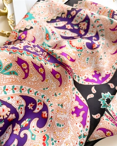 Macro view of vintage paisley print silk scarf with purple and orange patterns