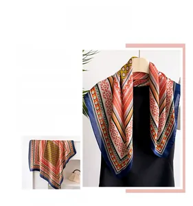 Detail of vintage square silk scarf with floral geometric pattern and smooth texture