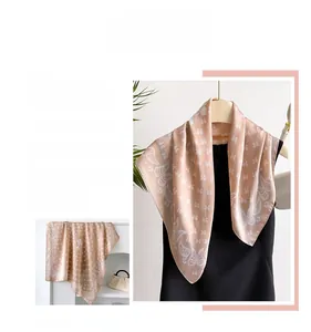 Close-up of elegant champagne paisley pattern print on silky smooth fabric scarf