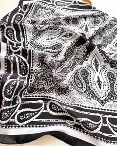 Detailed view of the soft paisley pattern and elegant texture on this silk-like neck scarf