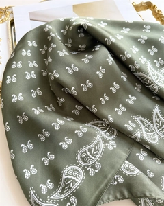 Close-up of olive green paisley silk scarf with satin luster and detailed stitching