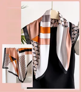 Detailed view of houndstooth silk scarf showing geometric patterns and smooth texture