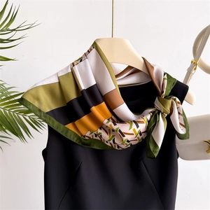 Classic houndstooth silk scarf tied in an elegant bow for professional office wear