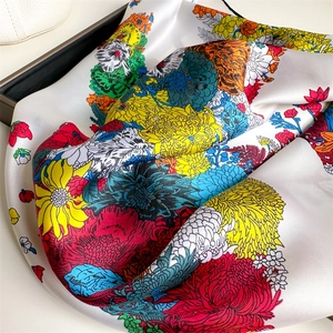 Elegant floral silk scarf featuring vibrant multi-color flower prints on creamy base
