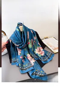 Detail of royal blue silk scarf with pink floral print draped over a black suit jacket