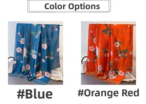 Close-up of floral print silk-feel scarves in blue and orange-red with polka dot borders