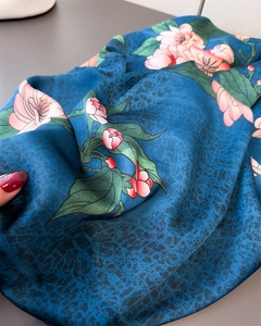 Detailed macro view of the glossy satin fabric with pink floral and leopard print