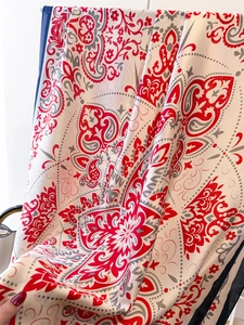Detailed view of paisley silk scarf showing soft drape and vibrant floral patterns
