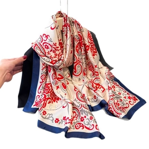 Faux silk paisley scarf with floral patterns and deep blue border in a draped view