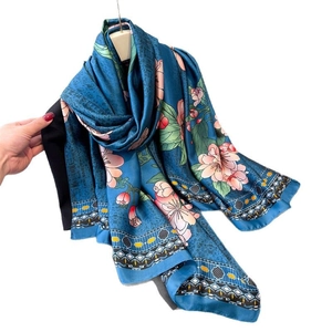 Teal silk-like floral scarf with pink cherry blossoms and geometric border pattern