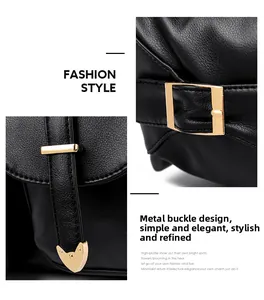 Detail van zwarte leren tas met goudkleurige metalen gespen en hoekbeschermers op de tas