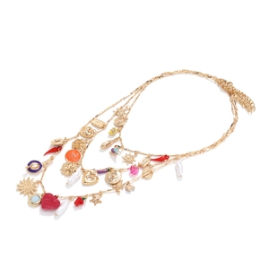 Bohemian multilayered gold necklace with heart, chili, and pearl pendants on white background