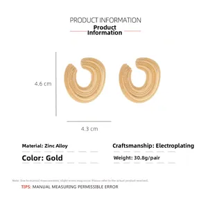 Detailed close-up of textured gold C-shaped earrings with dimensions and specifications