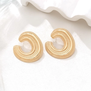 Retro golden C-shaped alloy earrings with hollow texture and granulation on stone surface