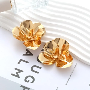 Dramatic gold oversized 3D flower earrings with a polished metallic mirror finish