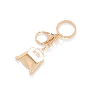 Elegant gold bride wedding dress keychain with white enamel and pearl details