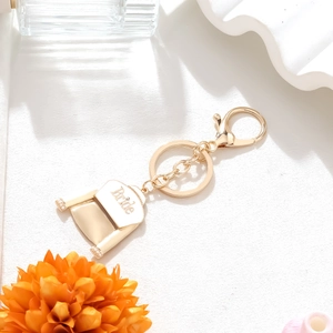 Gold-tone bridal dress keychain with white enamel Bride pendant and pearl accent