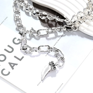 Silver thick chain necklace with animal horn pendant and black textured metal details