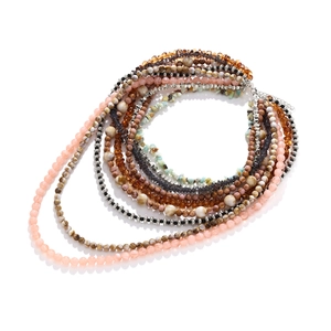 Detail of layered Bohemian beaded necklace featuring pink, marble, and silver faceted beads