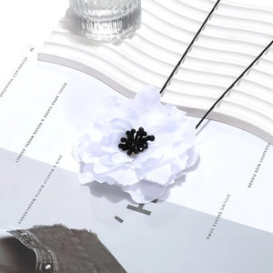 Handmade white layered fabric flower necklace with crystal center and black cord strap
