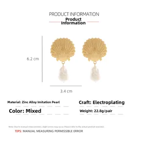Detail view of shell-shaped earrings with baroque pearls and specific size dimensions