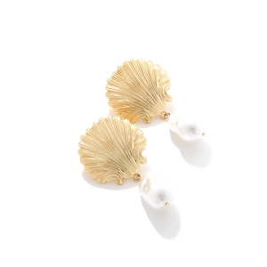 Golden shell earrings with baroque pearls in beach style on white background