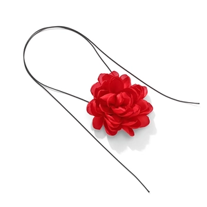 Close-up of a handmade red fabric flower choker with multilayered petals on black cord