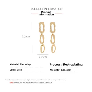 Detail view of gold layered geometric earrings showing 7.2cm length and hammered texture