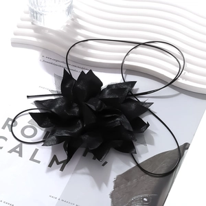 Detailed view of handmade black fabric layered flower choker with adjustable ribbon tie