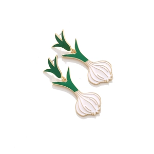 Detail of scalloped green and white enamel scallion earrings with gold alloy plating