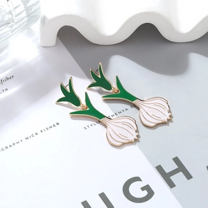 Creative enamel green onion dangle earrings in white and green with gold metal edges