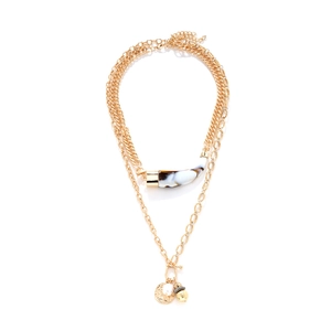Layered gold necklace featuring horn pendant, coin charm, and pearl on white background