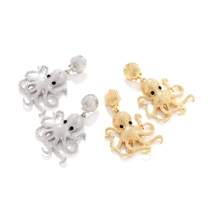 Detail of enamel octopus earrings with shell stud and textured metal finish