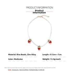 Detail view of handmade pearl bead necklace with red strawberry pendants and sizing info