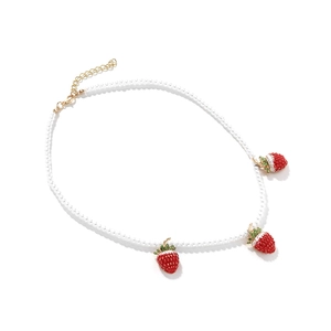 Handmade Baroque pearl necklace featuring vibrant red strawberry pendants with gold clasp
