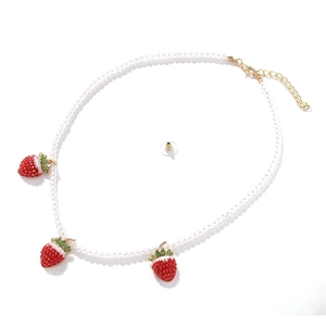 Baroque faux pearl necklace with three red strawberry pendants and green crystal leaves